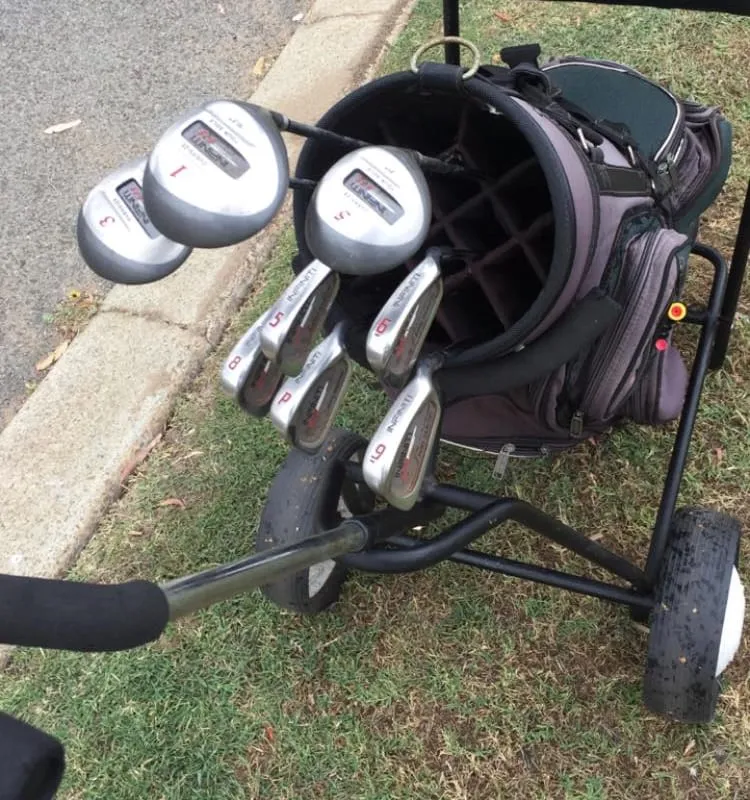 A second-hand starter set of irons and woods loaded onto a pull cart